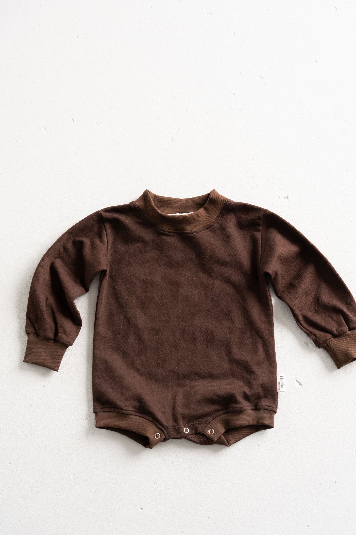 Cotton puff print romper in chocolate brown for babies and toddlers with puff print logo