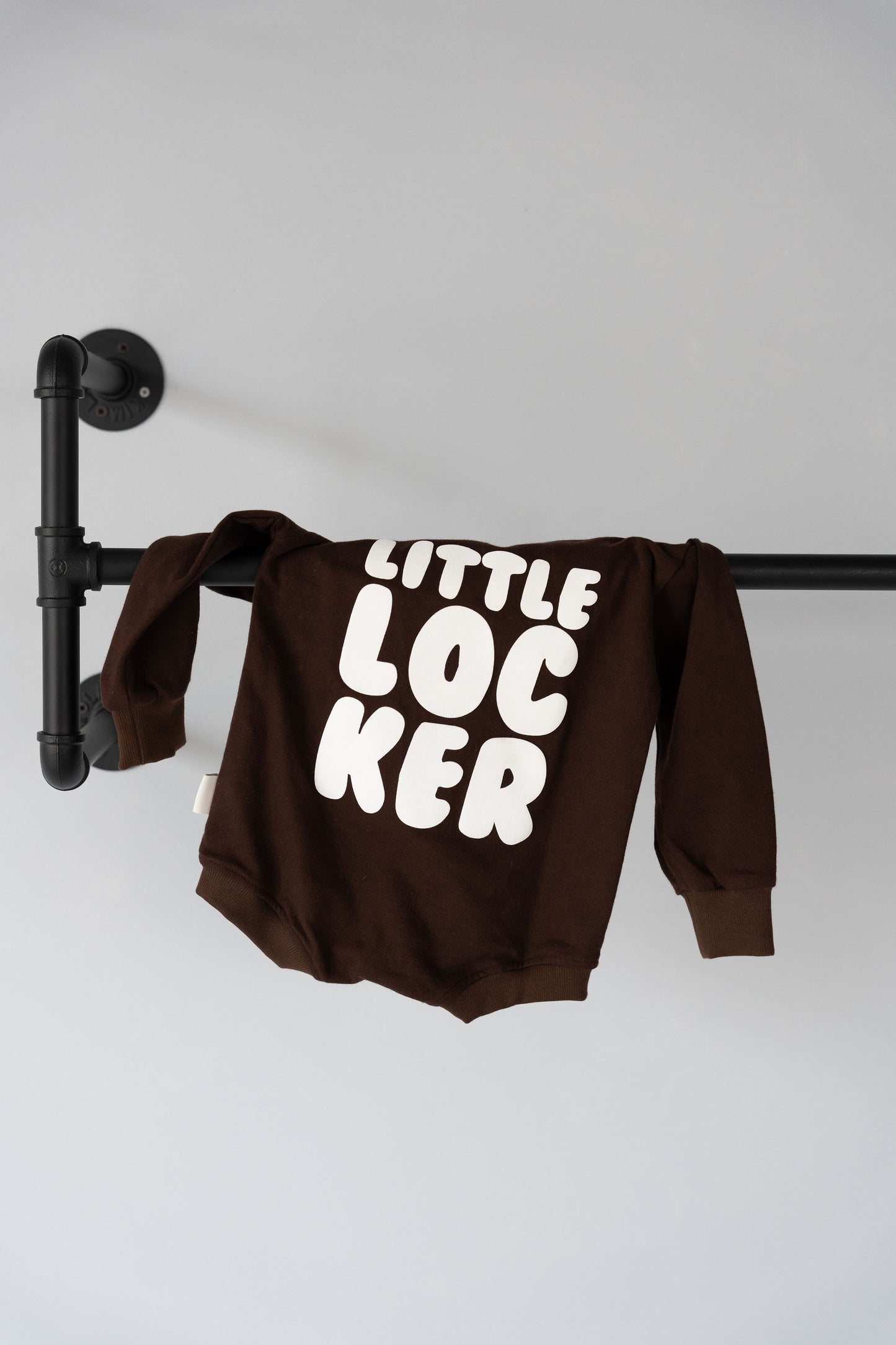 Cotton puff print romper in chocolate brown for babies and toddlers with puff print logo