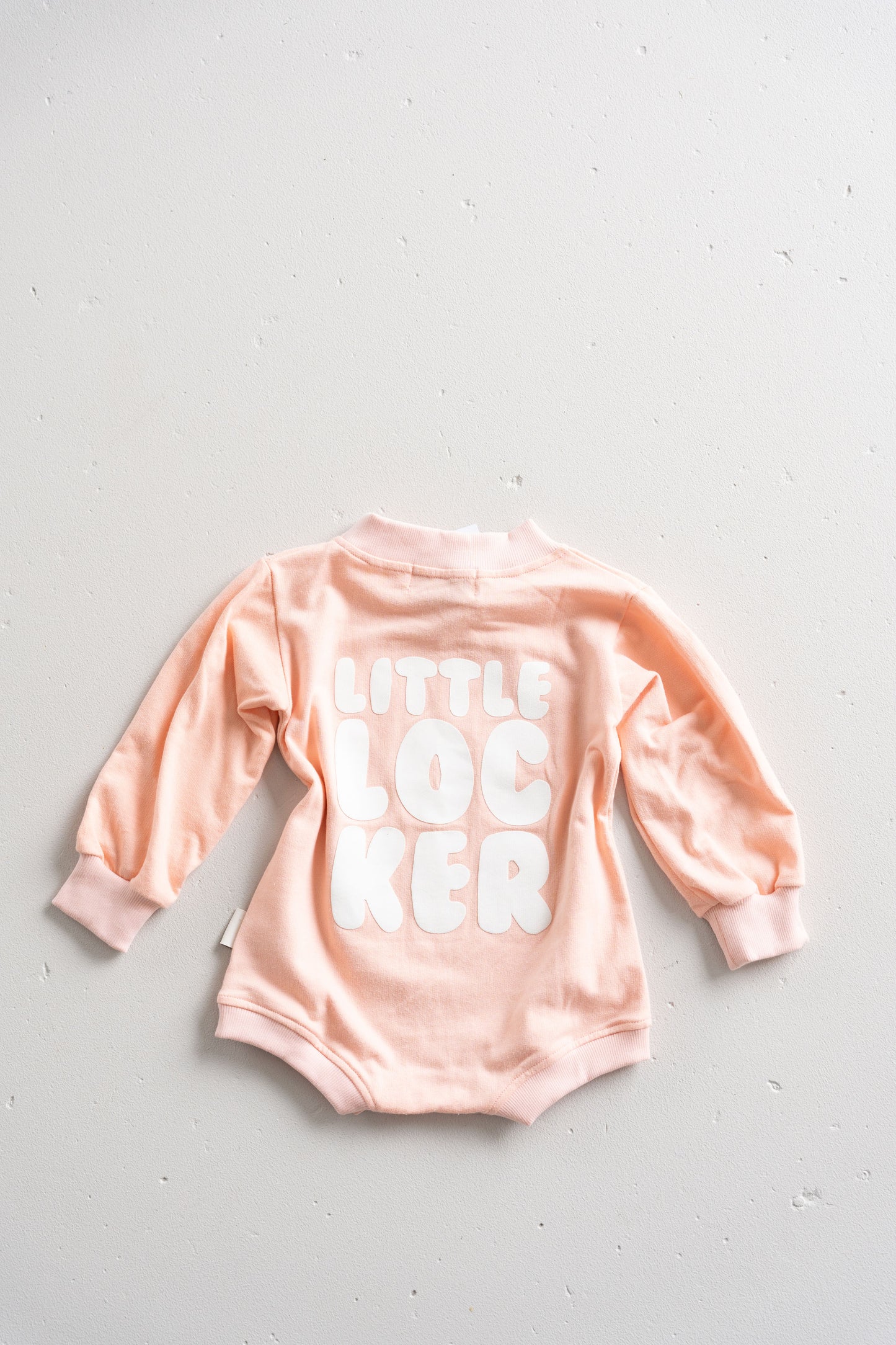 Cotton puff print romper in musk pink for babies and toddlers with puff print logo