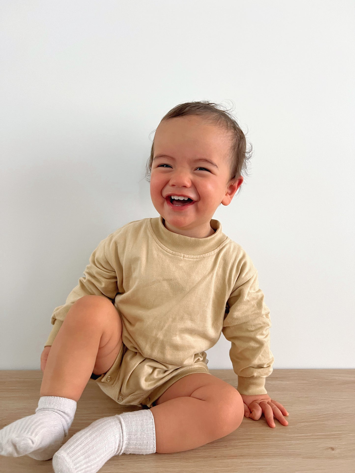 Cotton puff print romper in chocolate brown for babies and toddlers with puff print logo