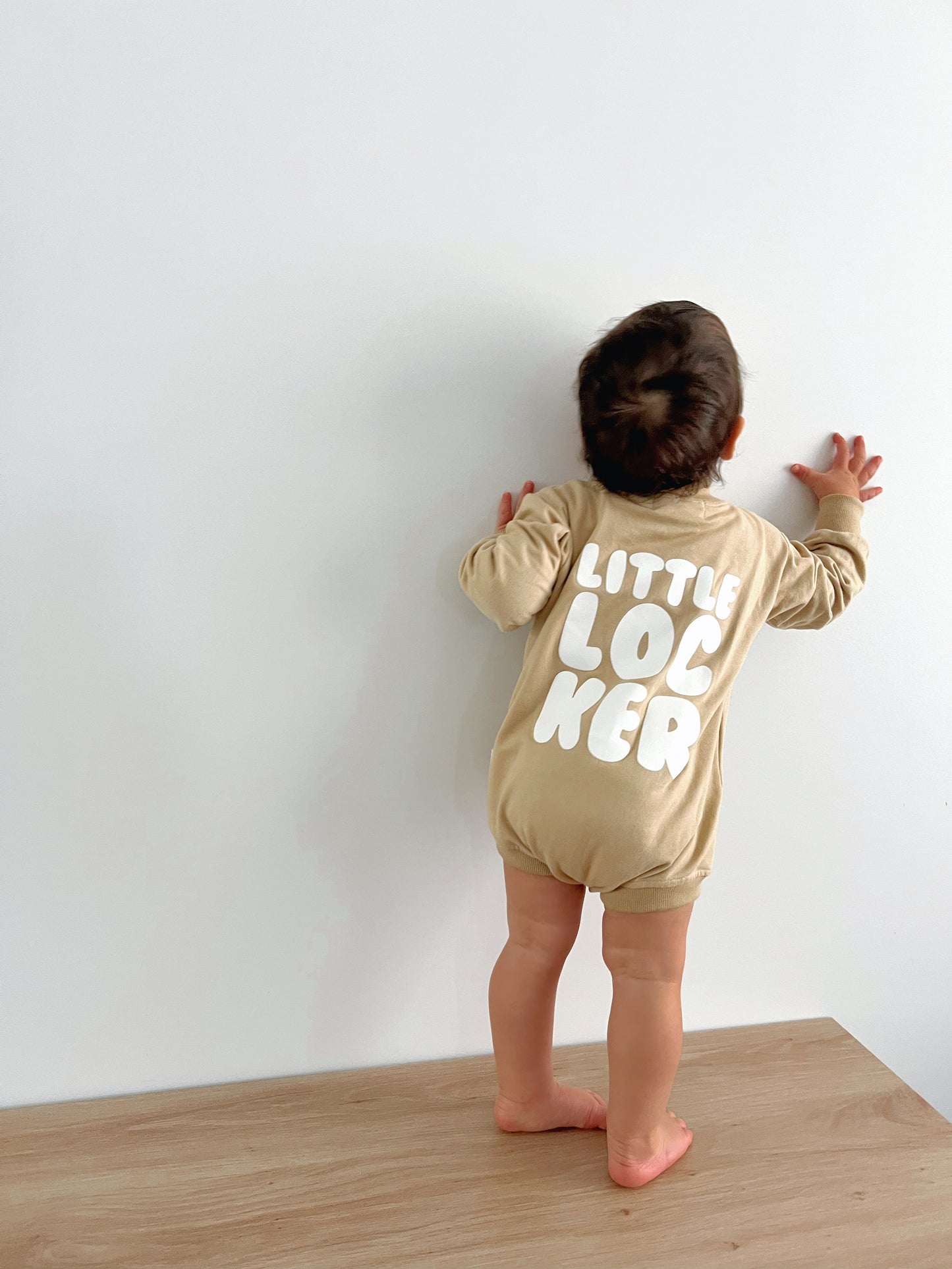 Cotton puff print romper in chocolate brown for babies and toddlers with puff print logo