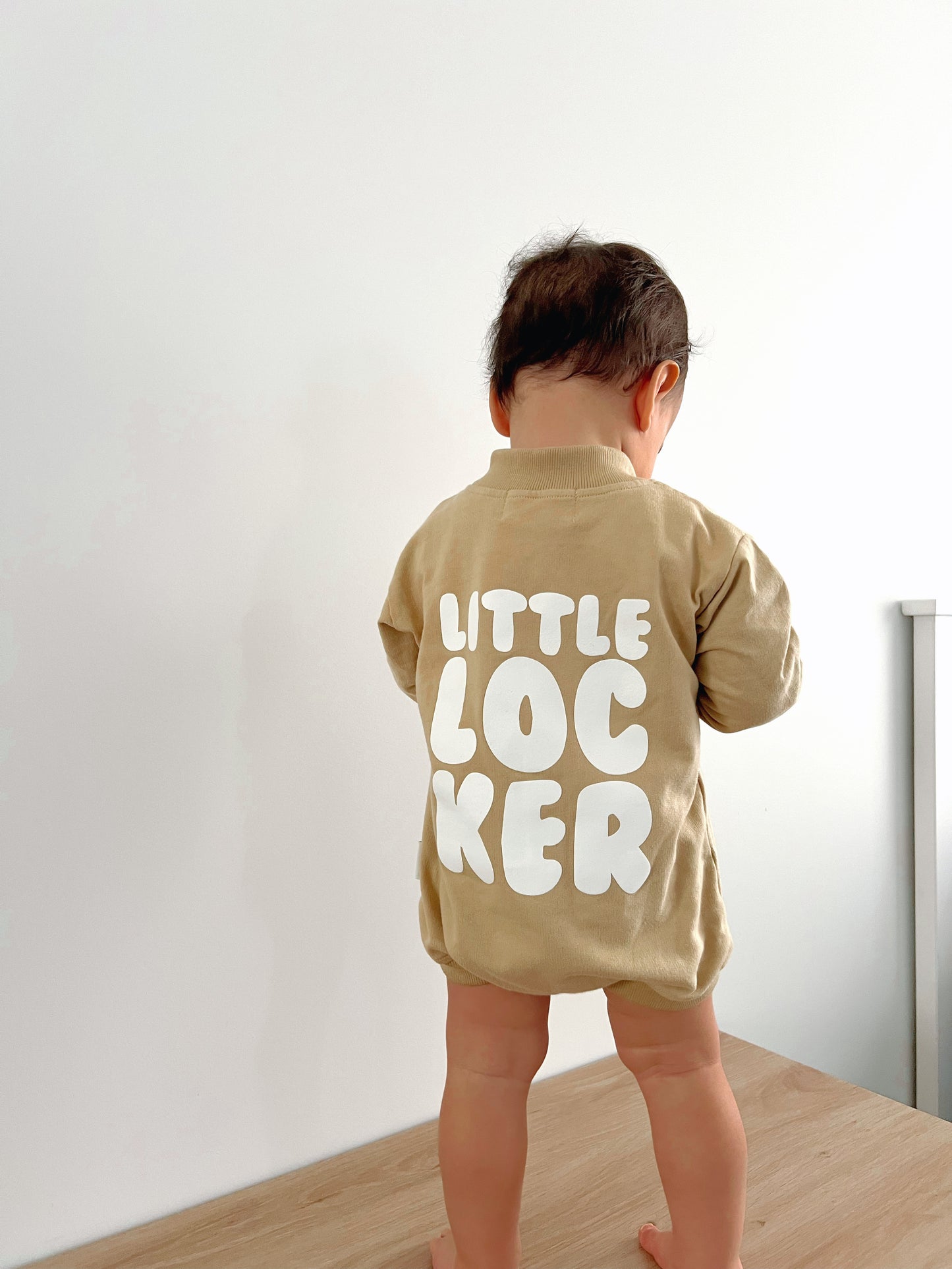 Cotton puff print romper in chocolate brown for babies and toddlers with puff print logo