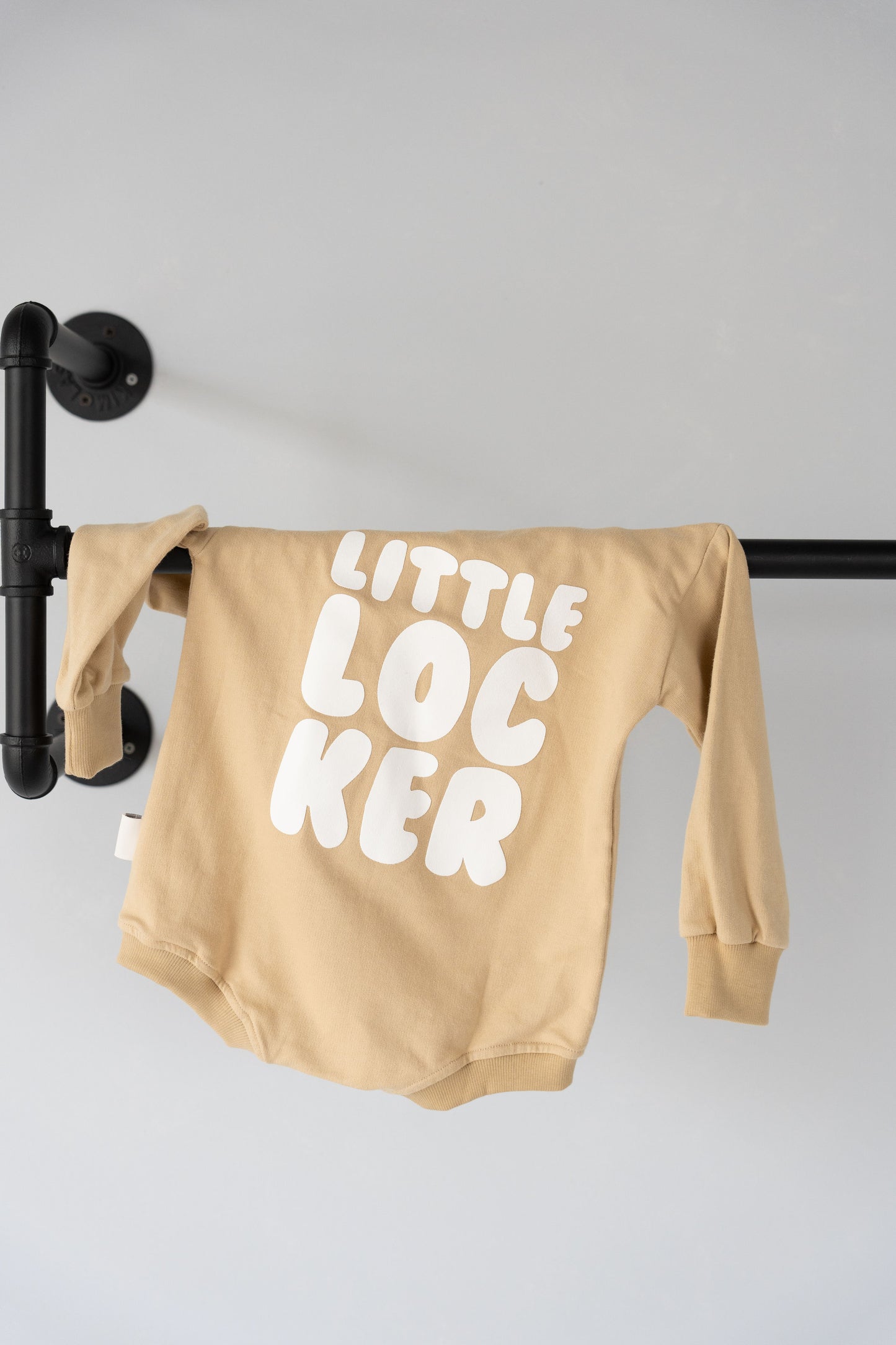 Cotton puff print romper in chocolate brown for babies and toddlers with puff print logo