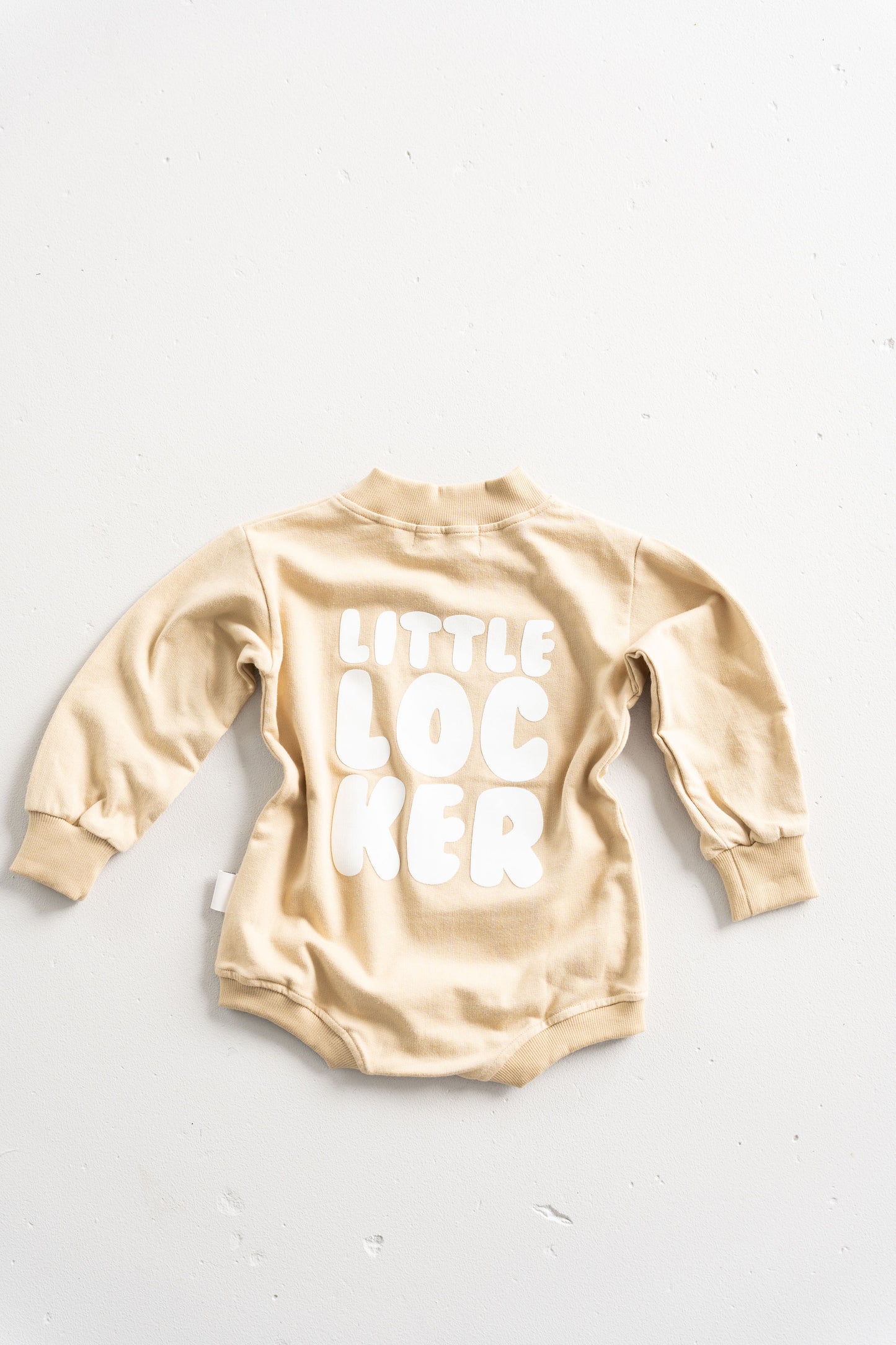 Cotton puff print romper in chocolate brown for babies and toddlers with puff print logo