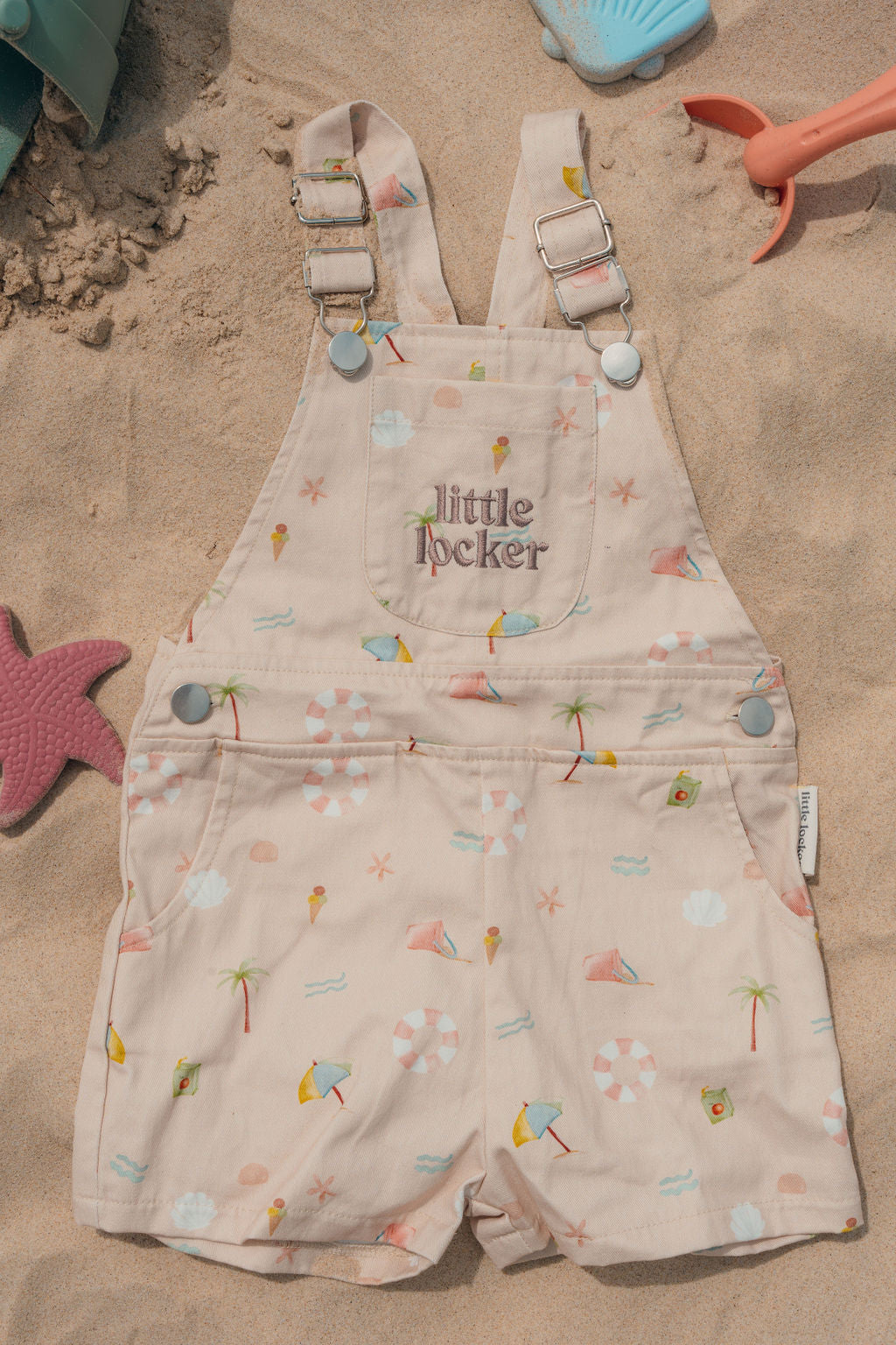 Ethically made gender-neutral summer overall with beach-inspired print