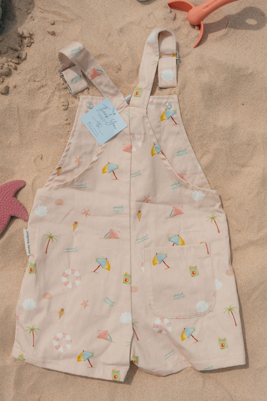 Ethically made gender-neutral summer overall with beach-inspired print