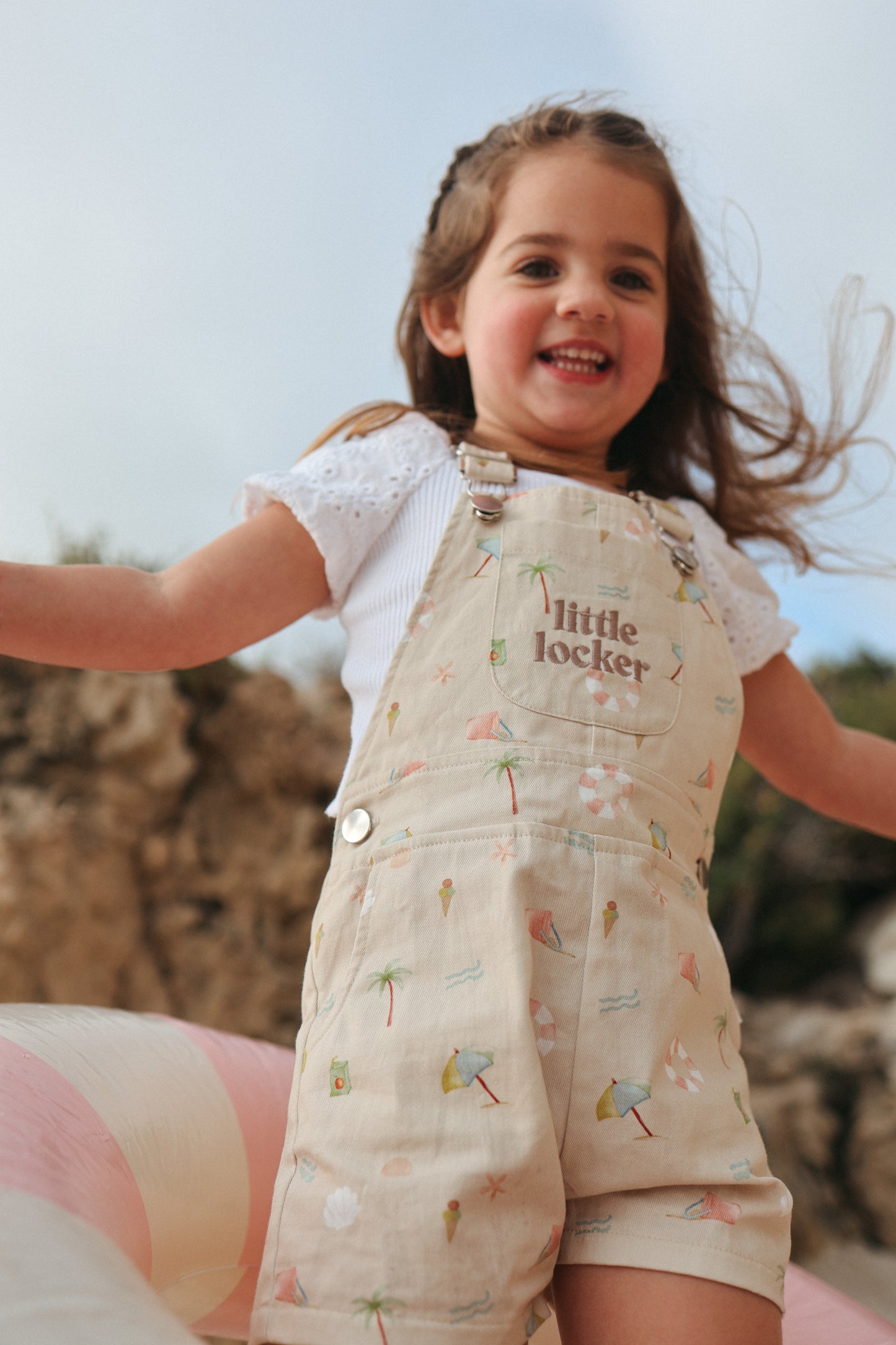 Ethically made gender-neutral summer overall with beach-inspired print