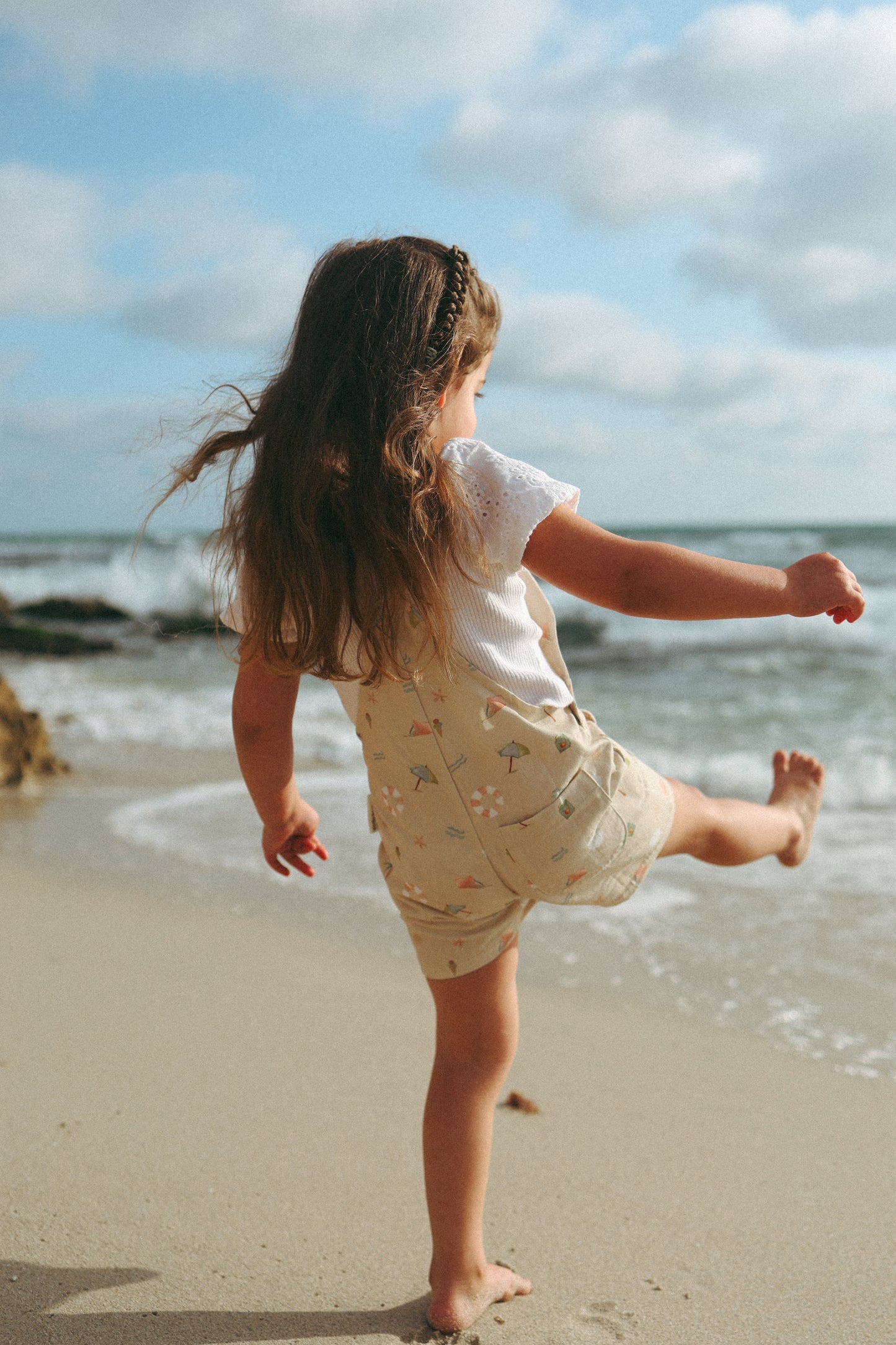 Ethically made gender-neutral summer overall with beach-inspired print