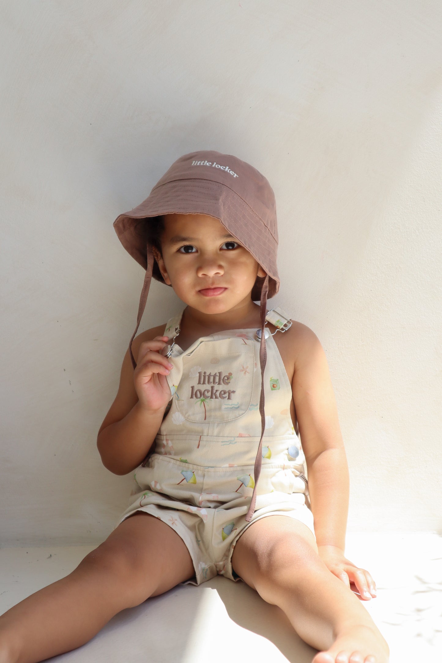 Ethically made gender-neutral summer overall with beach-inspired print