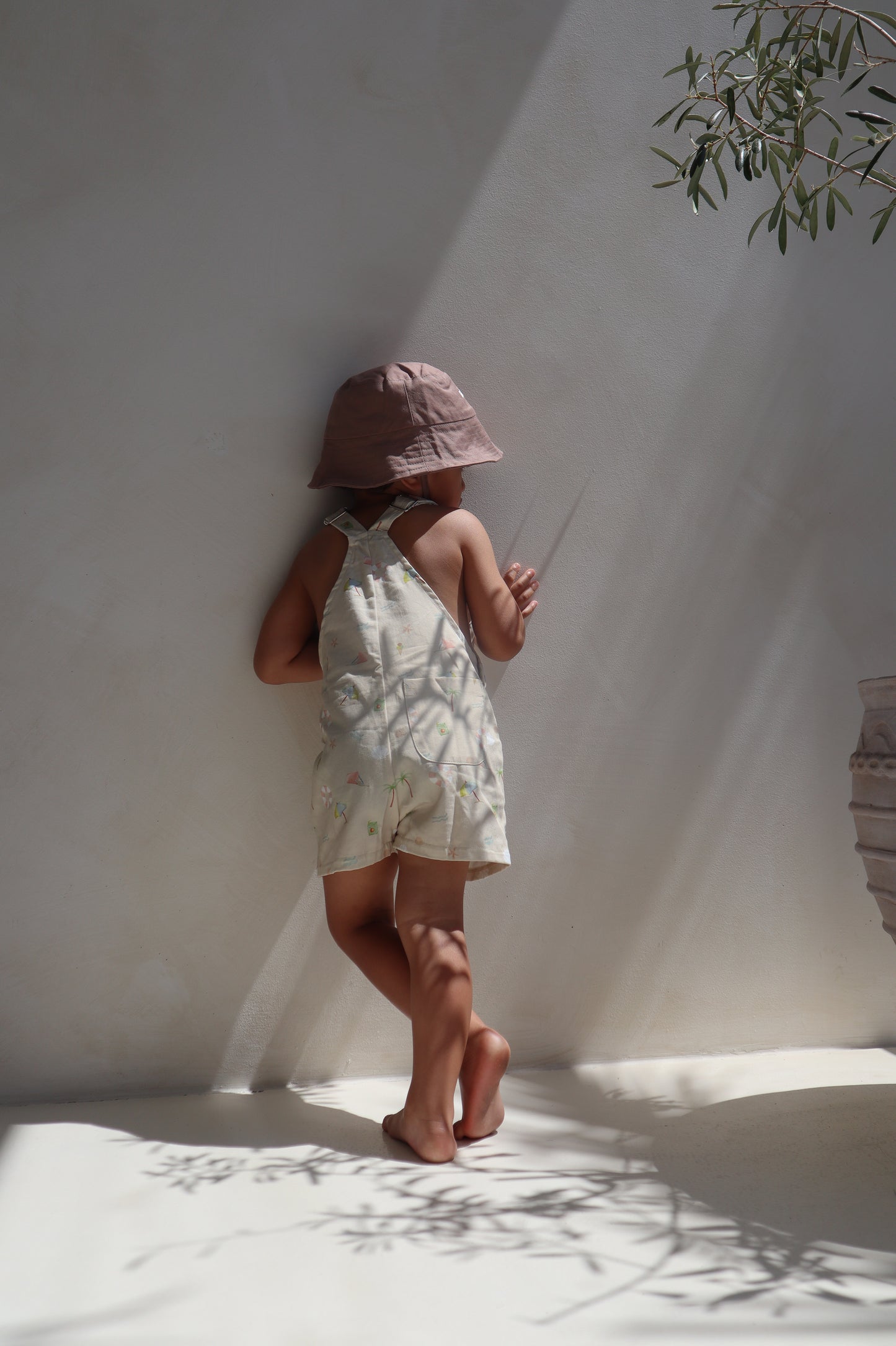 Ethically made gender-neutral summer overall with beach-inspired print