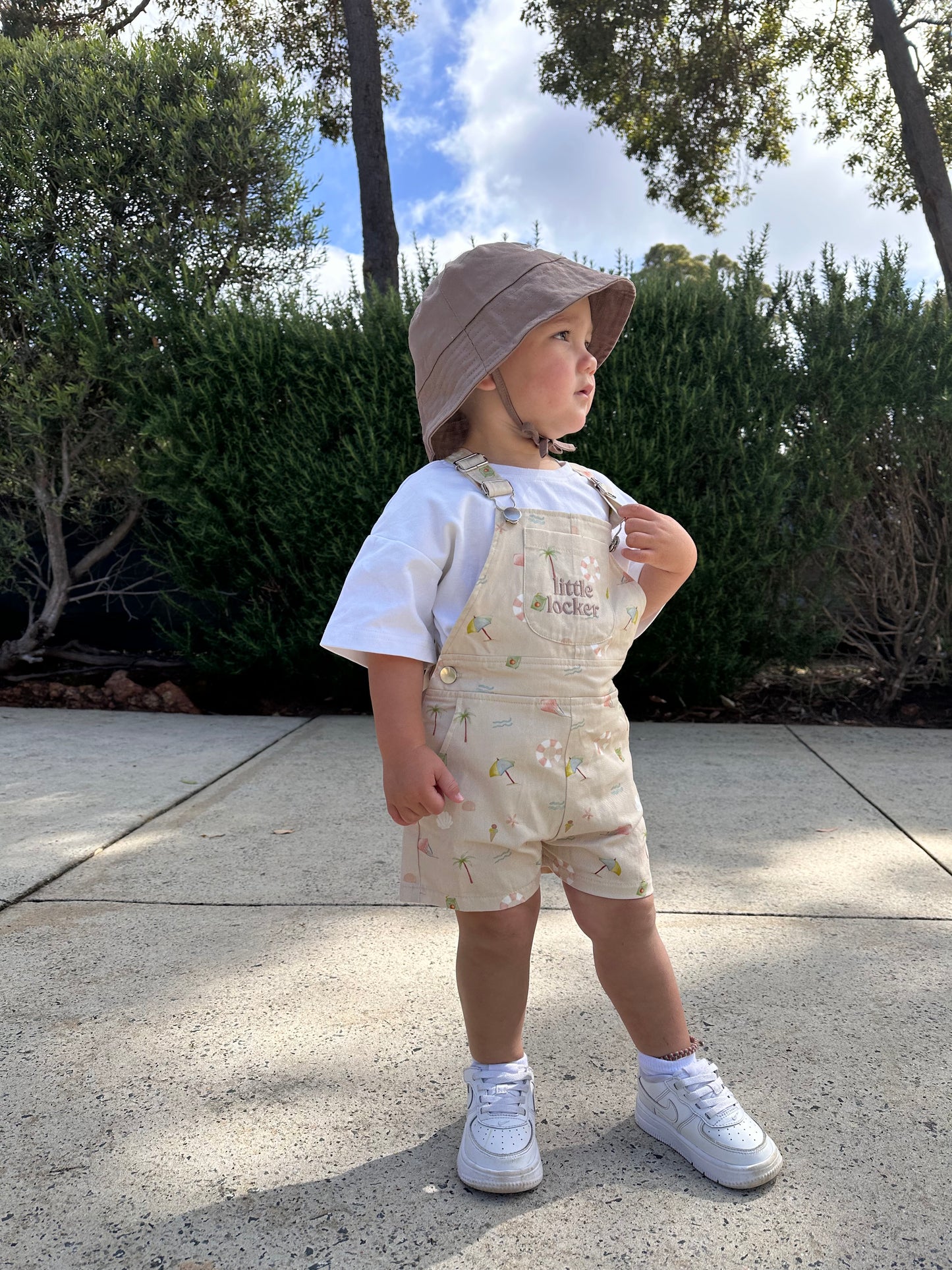 Ethically made gender-neutral summer overall with beach-inspired print