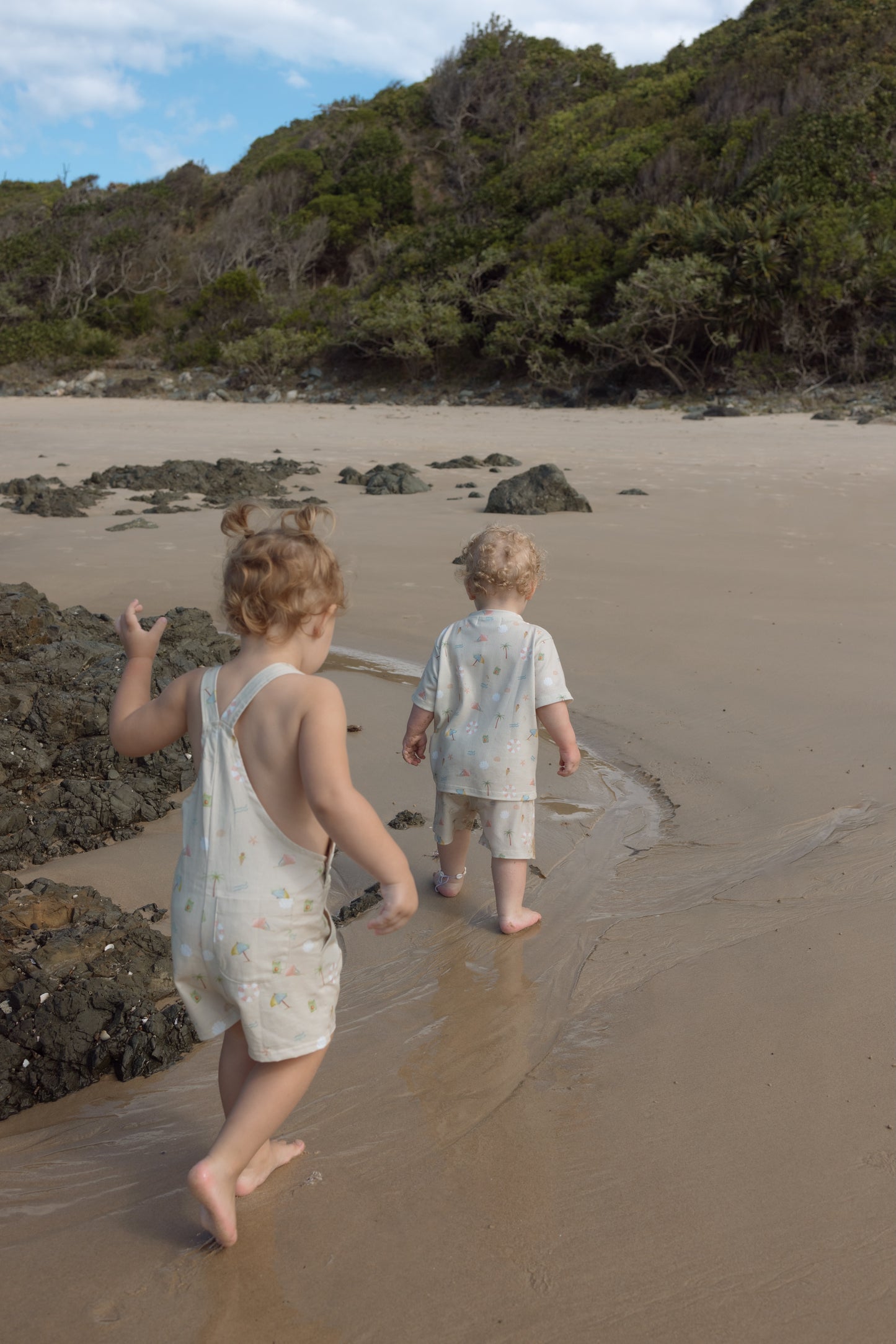 Ethically made gender-neutral summer overall with beach-inspired print