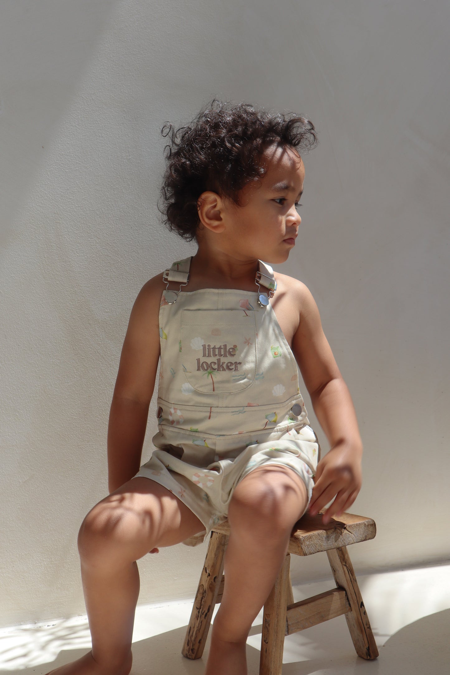 Ethically made gender-neutral summer overall with beach-inspired print
