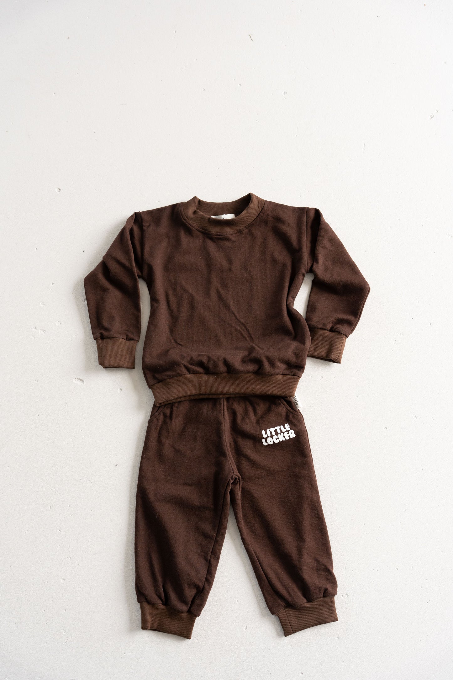 Neutral latte puff print track set for babies, toddler and kids. Made from soft cotton with relaxed fit and puff print logo