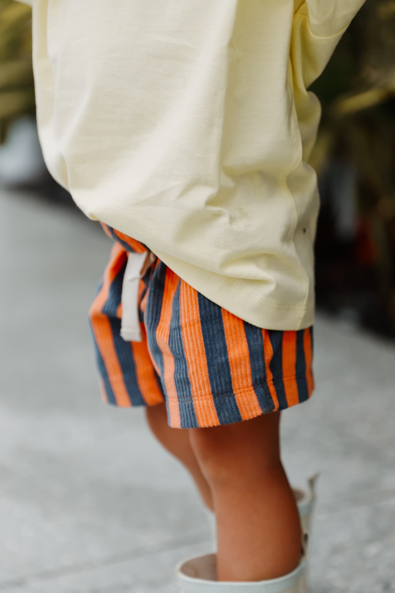 Cotton shorts for toddlers. Little Locker's Zinger shorts, in Navy/Orange. Featuring striped corduroy and an elastic waistband and drawstring.