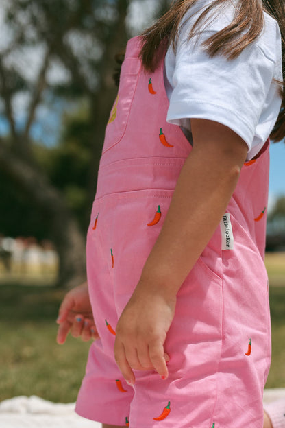 Little Locker pink cotton summer overalls with scattered chilli embroidery.