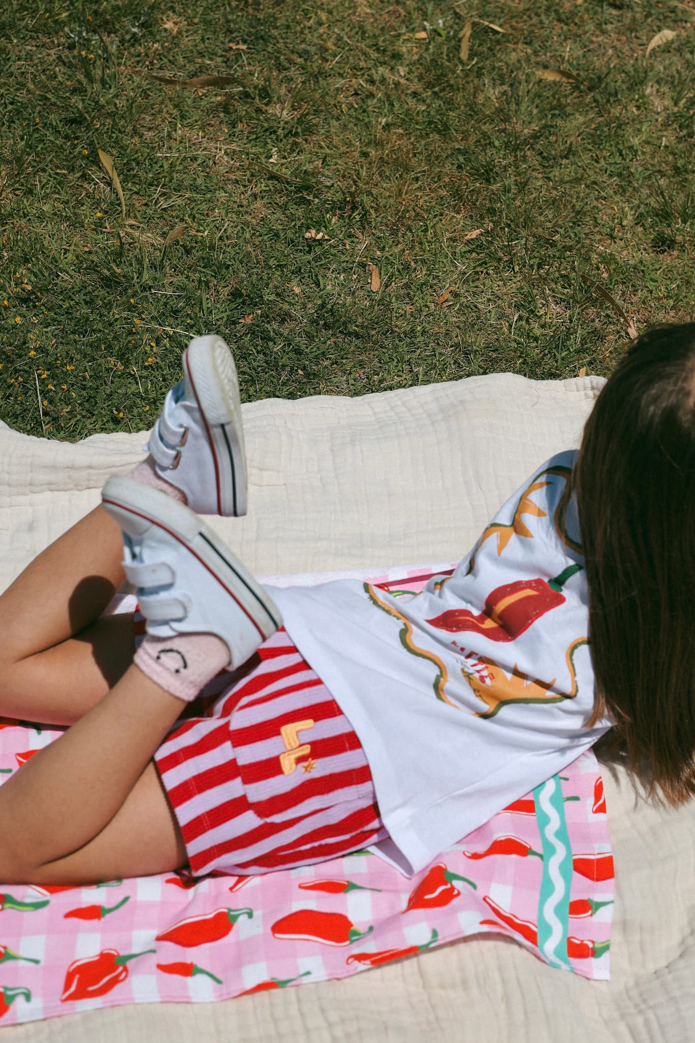Close-up detail of the "MOOD: spicy" tee and red chilli design on Little Locker's soft cotton kid's t-shirt.