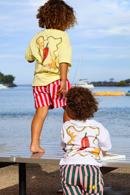 Two sisters wearing matching t-shirts with a chilli graphic design by Camellia Pickle.