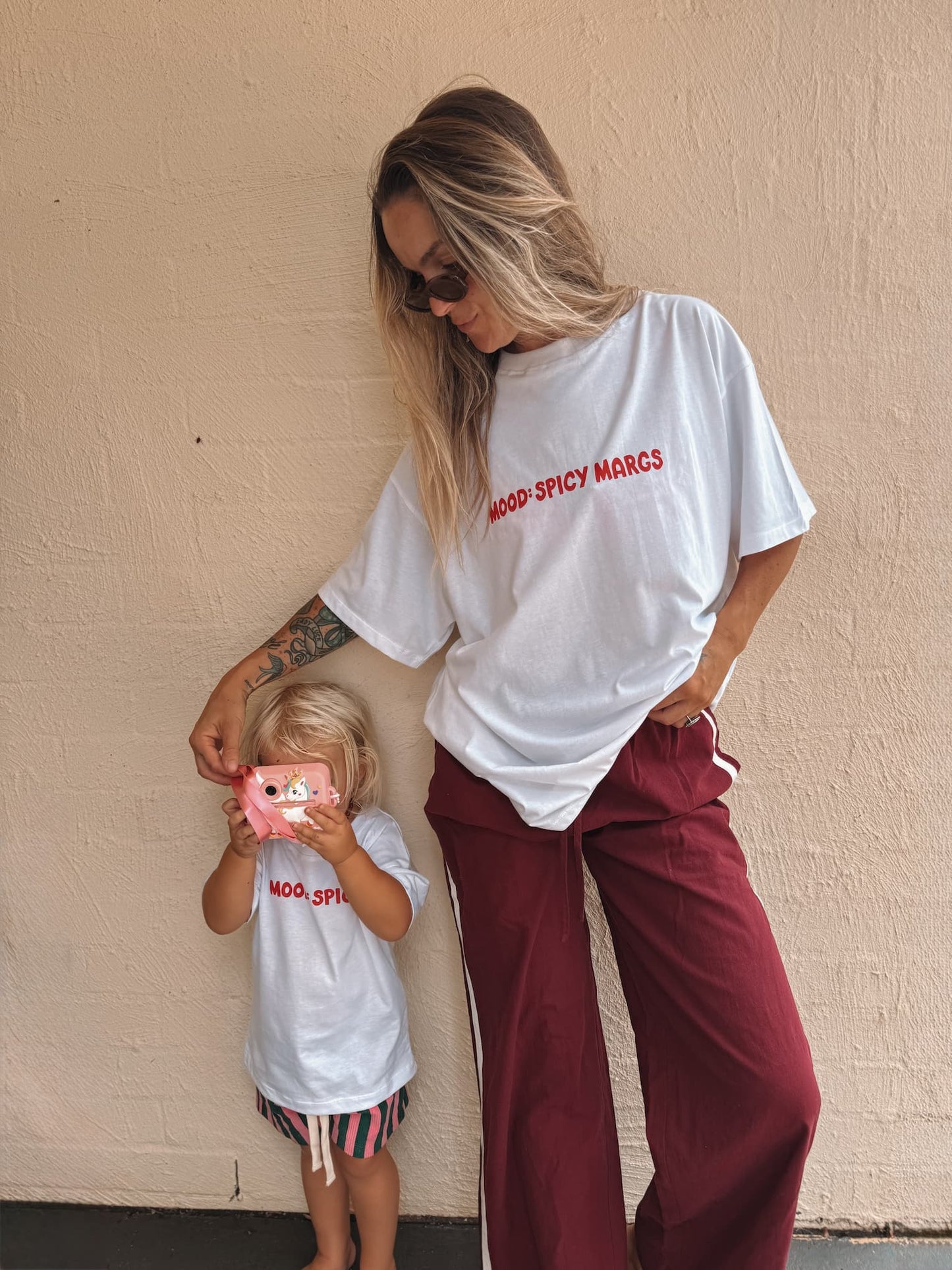 Mum and daughter wearing matching 'MOOD: Spicy' and 'MOOD: Spicy Margs' tshirts by Little Locker. 100% cotton and oversized.