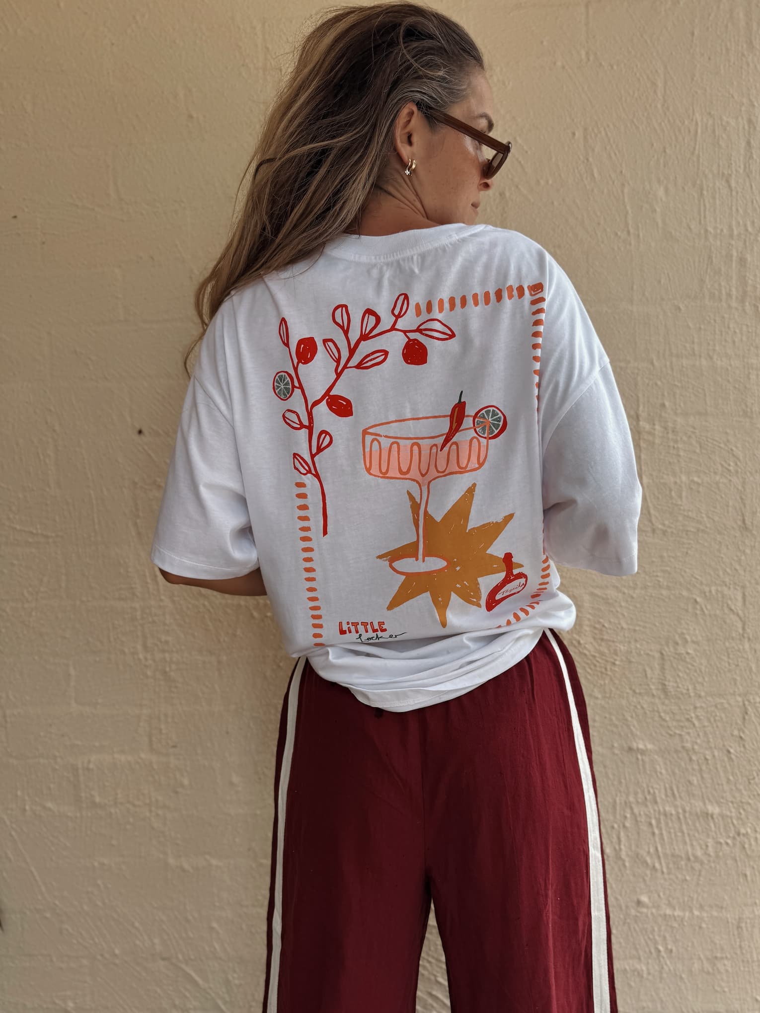 Woman wearing Little Locker oversized chllli graphic t-shirt in white, made from the 100% cotton fabric. A relaxed stylish outfit.