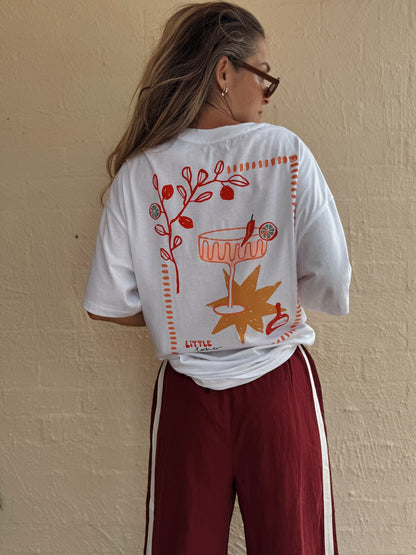 Woman wearing Little Locker oversized chllli graphic t-shirt in white, made from the 100% cotton fabric. A relaxed stylish outfit.