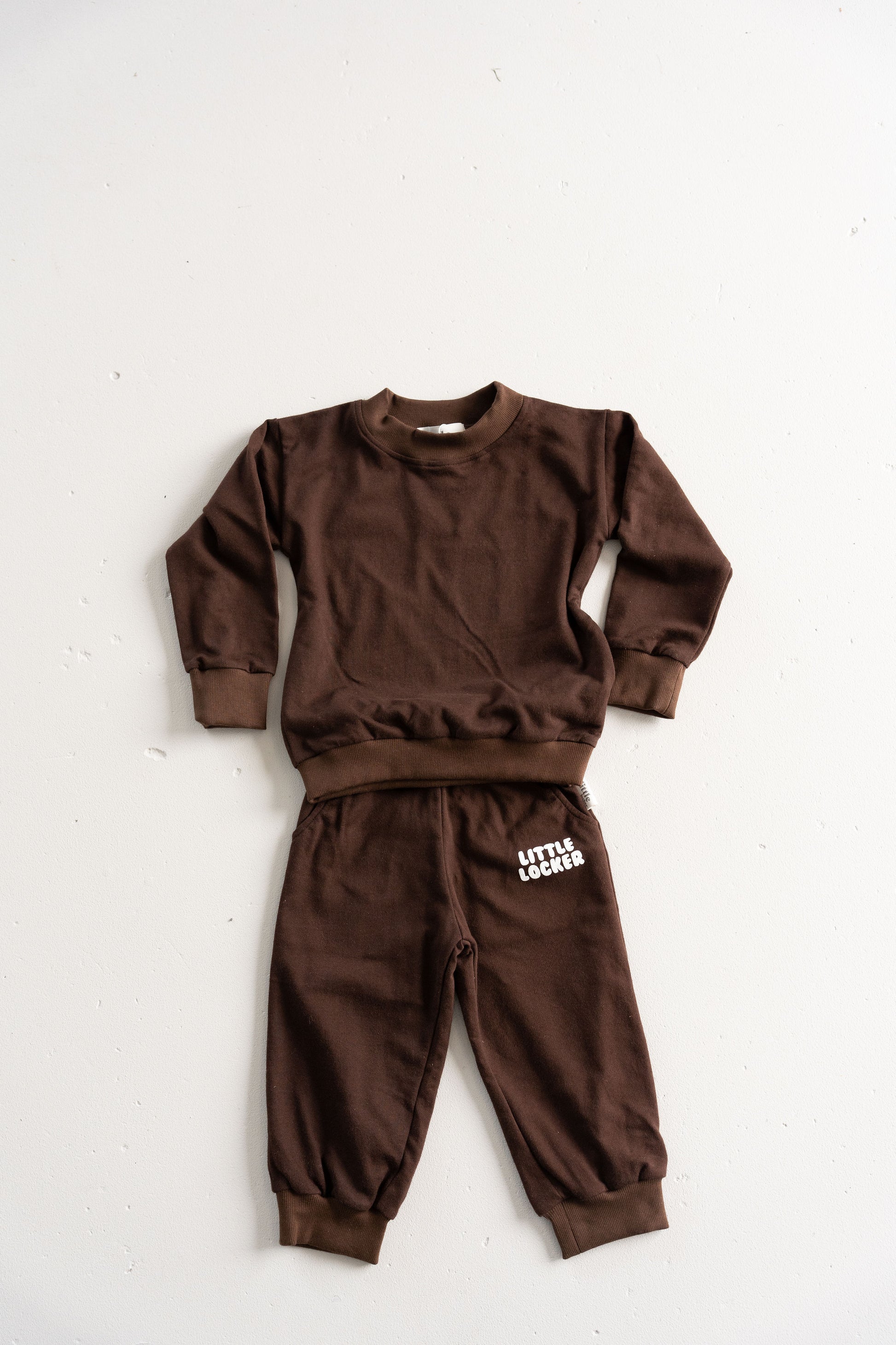 Neutral latte puff print track set for babies, toddler and kids. Made from soft cotton with relaxed fit and puff print logo
